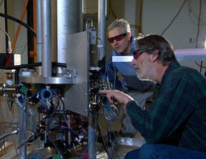 NIST physicists Steve Jefferts (foreground) and Tom Heavner with the NIST-F2 "cesium fountain" atomic clock, a new civilian time standard for the United States. Credit: NIST